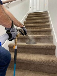 carpet cleaning technician steam cleaning carpeted stairs in San Antonio TX